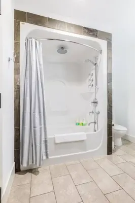 a bathroom with a shower and a toilet at Pooches Paradise - Pet Friendly Hot Tub & Pool in Canmore