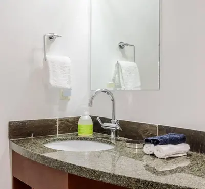 a bathroom counter with a sink and a mirror at Pooches Paradise - Pet Friendly Hot Tub & Pool in Canmore