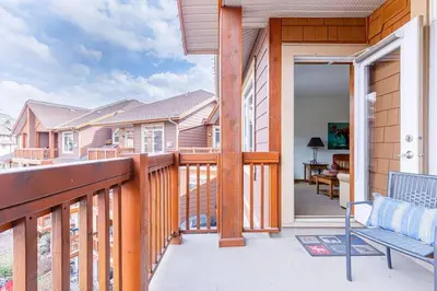 a balcony with a bench and a table on a house at Mountain Paradise at Falcon Crest Lodge in Canmore