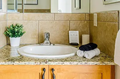 a bathroom sink with towels on a counter at Mountain Paradise at Falcon Crest Lodge in Canmore