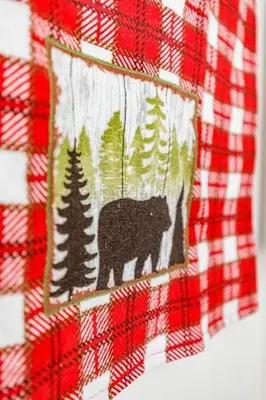 a picture of a black bear on a plaid shirt at Mountain Paradise at Falcon Crest Lodge in Canmore