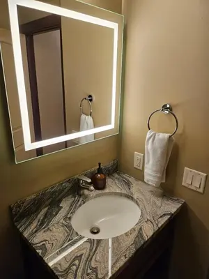 a bathroom with a sink and a mirror at Falcon Crest Canmore Banff in Canmore
