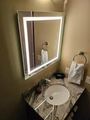 a bathroom with a sink and a mirror at Falcon Crest Canmore Banff in Canmore