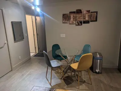 a room with a glass table and four chairs at Breath Taking View for 4Guest DTskyline-22nd Floor in Calgary