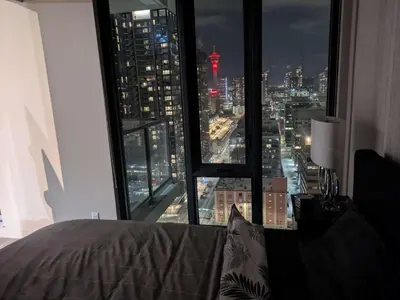 a bedroom with a view of a city at night at Breath Taking View for 4Guest DTskyline-22nd Floor in Calgary