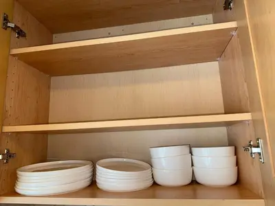 a cupboard with four white bowls in it at 2Bed Bright & Stylish Ritchie Urban Retreat in Edmonton