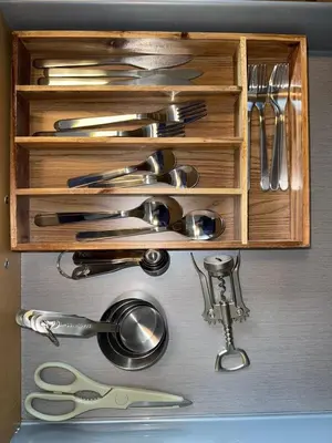 a wooden drawer filled with utensils and a bunch of scissors at 2Bed Bright & Stylish Ritchie Urban Retreat in Edmonton