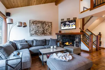 a living room with a couch and a fireplace at Best Location Available in Whistler Village in Whistler