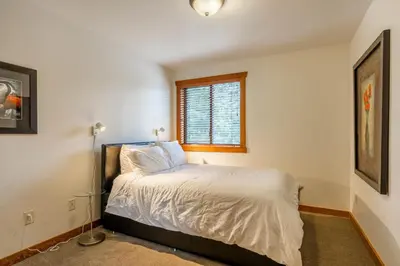 a bedroom with a bed and a window at Best Location Available in Whistler Village in Whistler
