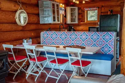 a kitchen with a table and four stools at Eagle Nest by StayIn in Fairmont Hot Springs