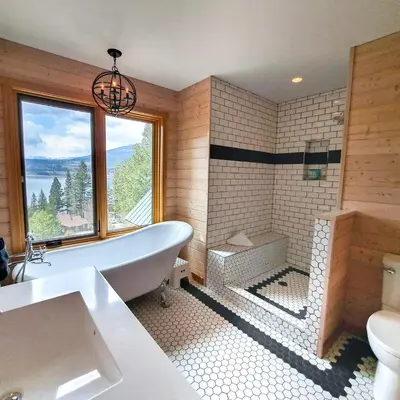a large bathroom with a tub and a window at Eagle Nest by StayIn in Fairmont Hot Springs