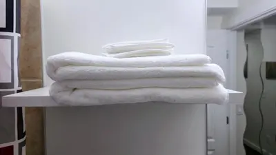 a pile of towels sitting on a counter in a bathroom at Cozy & Spacious 1-Bedroom SW Calgary near SpruceMeadows in Calgary