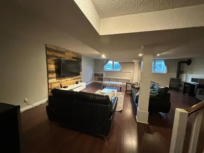 a living room with a couch and a tv at 1Bed Cozy Retreat & Spacious Lounge in Yellowknife