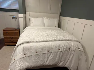 a bed with white sheets and pillows in a bedroom at 1Bed Cozy Retreat & Spacious Lounge in Yellowknife