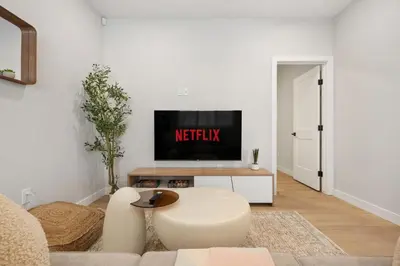 a living room with a couch and a tv at 2 Bedroom Spacious & Private Guest Suite - King Size Bed TV in Room, 58