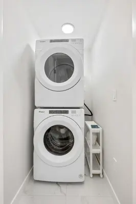 a washing machine and a dryer in a room at 2 Bedroom Spacious & Private Guest Suite - King Size Bed TV in Room, 58