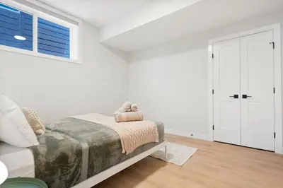 a white bedroom with a bed and a window at 2 Bedroom Spacious & Private Guest Suite - King Size Bed TV in Room, 58