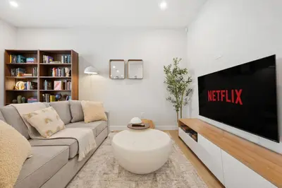 a living room with a couch and a flat screen tv at 2 Bedroom Spacious & Private Guest Suite - King Size Bed TV in Room, 58