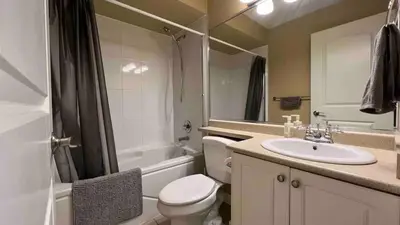 a bathroom with a toilet and a sink and a shower at Spacious comfy stay in Richmond