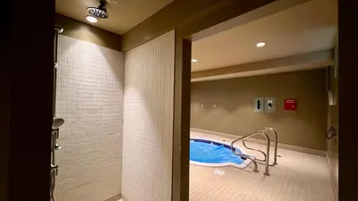 a bathroom with a shower and a tub in a room at 901 Fernie by StayIn in Fernie