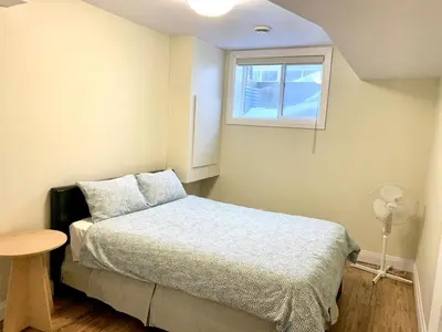 a small bedroom with a bed and a window at Spacious 6 beds 3 baths home in Central WiFi parking AC in Edmonton
