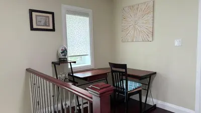a desk and chair in a room with a window at Spacious 6 beds 3 baths home in Central WiFi parking AC in Edmonton