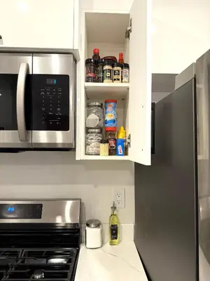 a kitchen with a refrigerator and a microwave at 2bed Lagos House Backyard Suites Downtown in Edmonton