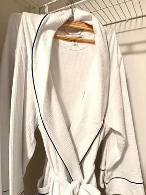 a white shirt on a hanger in a closet at 2bed Lagos House Backyard Suites Downtown in Edmonton