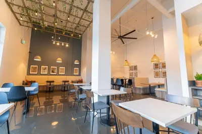 a restaurant with tables and chairs in a room at 2 bedrooms-3 beds 2 baths - Rocky Mountain View Retreat - Heated Pool and Hot Tub in Dead Man's Flats