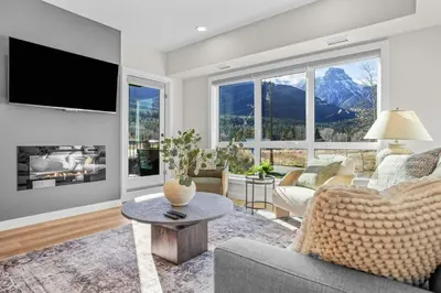 a living room with a couch and a tv at 2 bedrooms-3 beds 2 baths - Rocky Mountain View Retreat - Heated Pool and Hot Tub in Dead Man's Flats