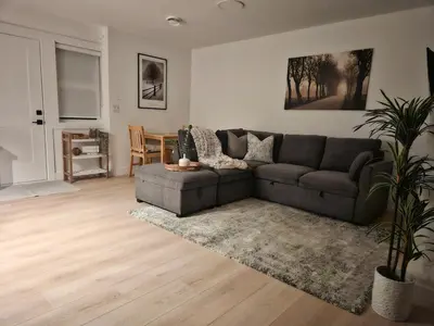 a living room with a couch and a table at Cozy new Suite in Silver Valley in Maple Ridge District Municipality