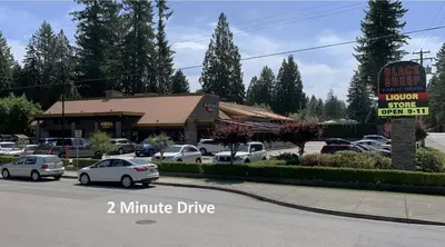 a parking lot with cars parked in front of a restaurant at Cozy new Suite in Silver Valley in Maple Ridge District Municipality