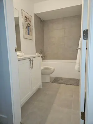 a bathroom with a toilet and a sink and a tub at Cozy new Suite in Silver Valley in Maple Ridge District Municipality