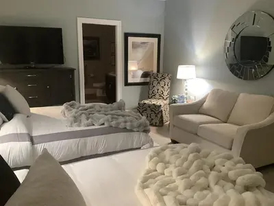 a living room with two couches and a tv at Sand and Salt Bed & Breakfast in White Rock