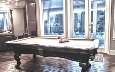a pool table in the middle of a room at Sand and Salt Bed & Breakfast in White Rock
