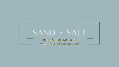 a blue and white sign for a sand it salt bed breakfast at Sand and Salt Bed & Breakfast in White Rock