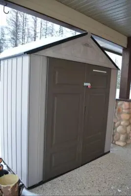 a garage with a roof with a large door at Stemwinder Duplex Chalet by StayIn in Kimberley