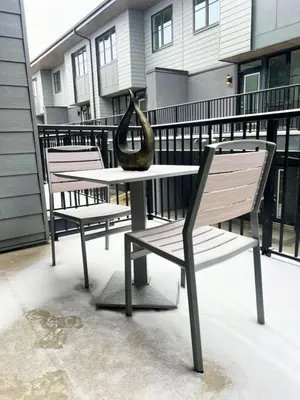 a vase sitting on top of a table on a balcony at Luxury 3 Bedrooms Spacious Townhome, 2 Car Garage, Sleeps 8, Heater & AC, King Bed, Easy Ski Access, Next to WinSport, 10km from Calgary Downtown, Near Banff in Calgary