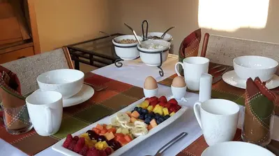 a table with a tray of fruit and eggs on it at Campbell Cottage B&B in Nanaimo