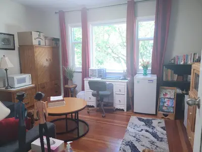 a living room with a desk and a table and a desk at Campbell Cottage B&B in Nanaimo
