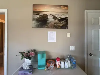 a bathroom counter with a picture on the wall at Rosehouse 2Bedrooms sleep 4 2nd floor private bathroom in Coquitlam