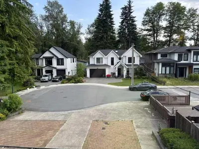 a driveway in a residential neighborhood with houses at Rosehouse 2Bedrooms sleep 4 2nd floor private bathroom in Coquitlam