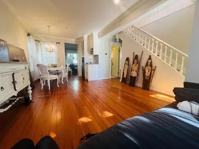 a living room with a wooden floor and a dining room at 3 level, home near downtown! in Vancouver