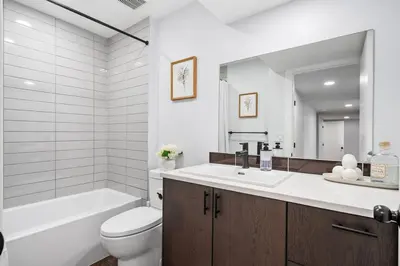 a bathroom with a sink and a toilet and a bath tub at Silver Springs Family Retreat in Calgary