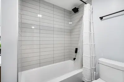 a white bathroom with a tub and a toilet at Silver Springs Family Retreat in Calgary