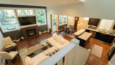 a living room with a couch and a fireplace at Charming scape by Bear Mountain in Victoria