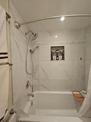 a bathroom with a white tub and a shower at The Ridge in North Vancouver