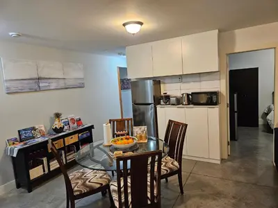 a kitchen with a table and chairs and a kitchen with a counter at The Ridge in North Vancouver