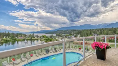 a balcony with a view of a lake and mountains at Heron Point by StayIn in Invermere
