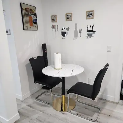 a table and two chairs with a candle on it at 2 bedrooms luxury basement suite close to Calgary airport in Calgary